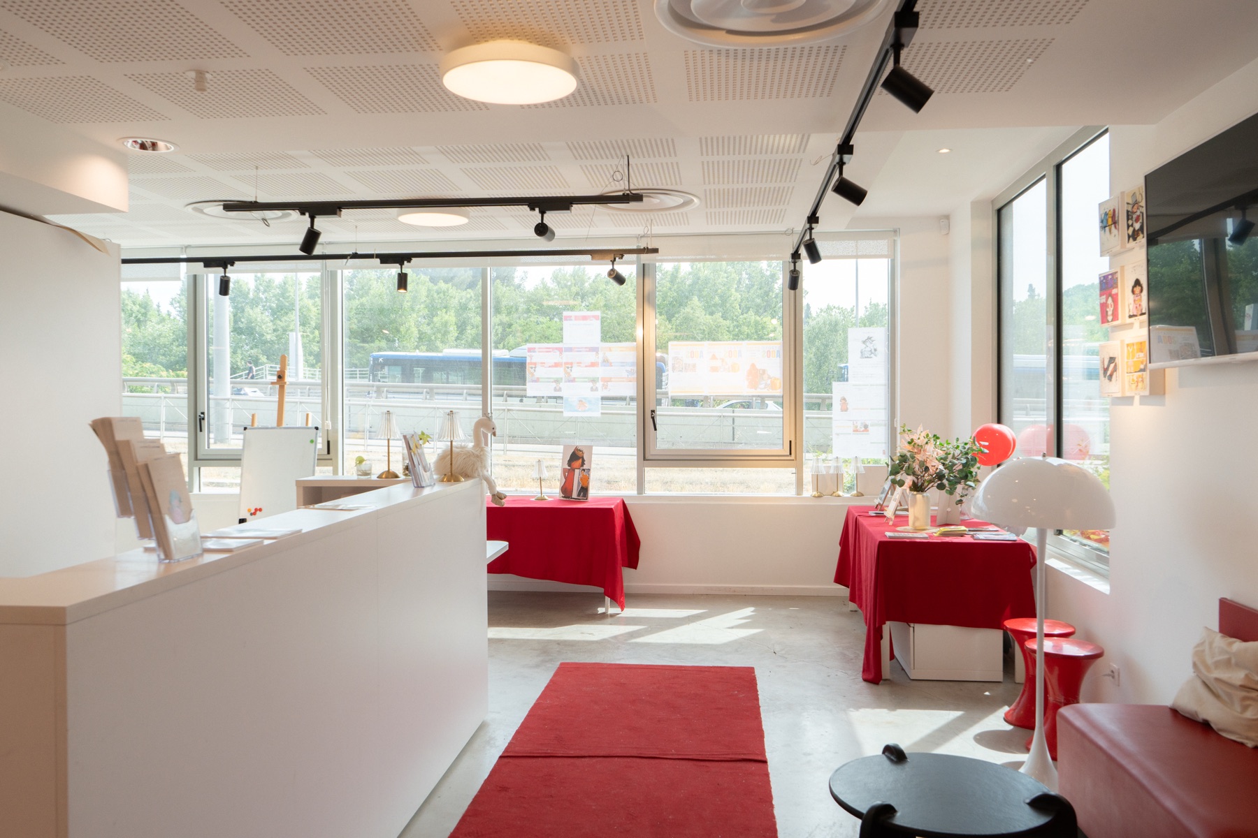L’espace blanc dans toute sa longueur : les baies vitrées, le comptoir et les tables de travail.